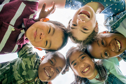 Kids in a circle smiling