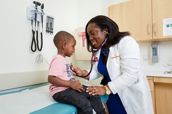 Dr. Theiline Gborkorquellie gives a boy a check up at THEARC.