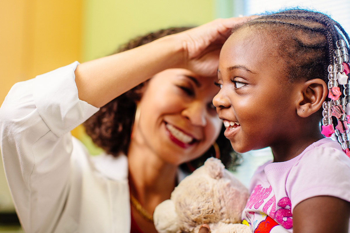 Female doctor looking in ear