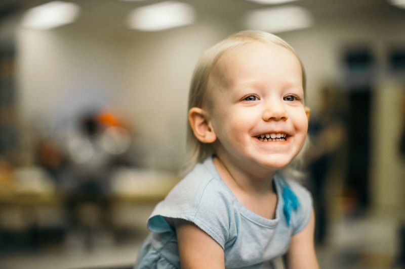 Happy smiling girl in exam room.