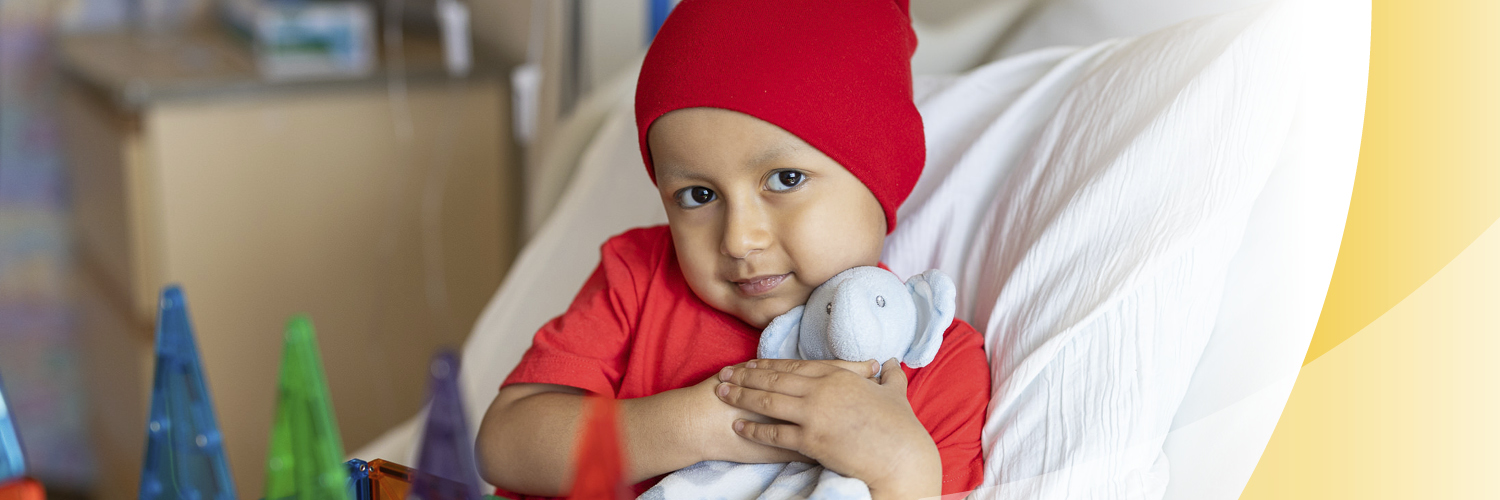 child with cancer in hospital bed