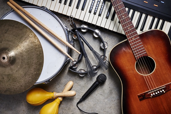 A guitar, drum, tambourine, keyboard, cymbal, maracas and microphone