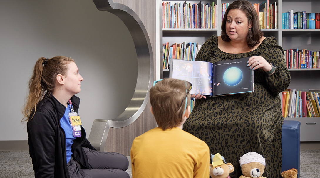 A patient enjoys story time in the Family Resource Center